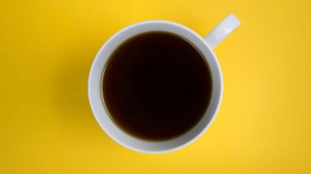 Koffie van boven op gele tafel