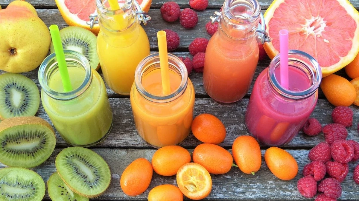 Gekleurde smoothies met fruit omringd
